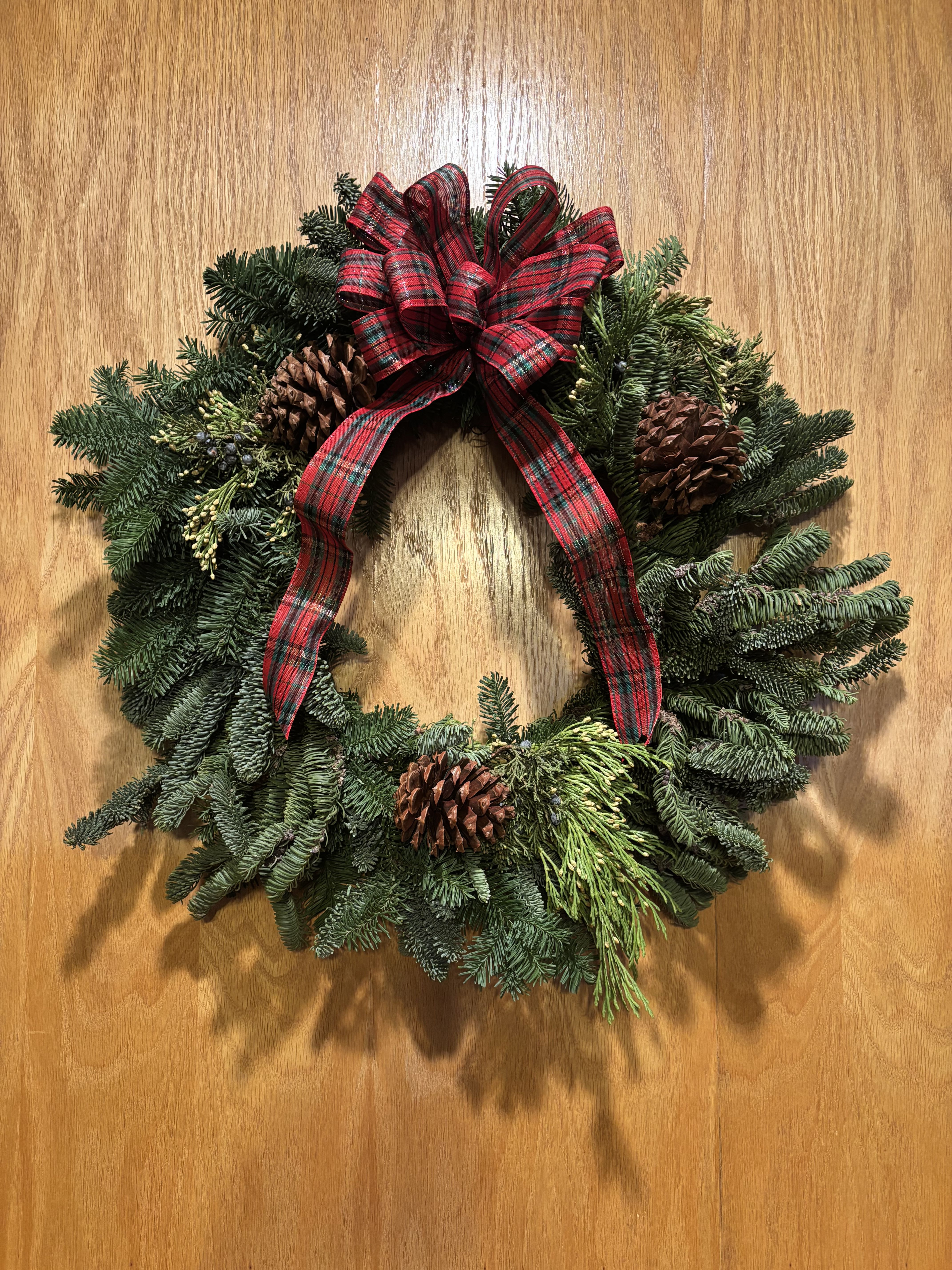 Fresh Holiday Wreath  - Beautiful live holiday wreath decorated with berries, pine cones, and ribbon. Available with or without lights.