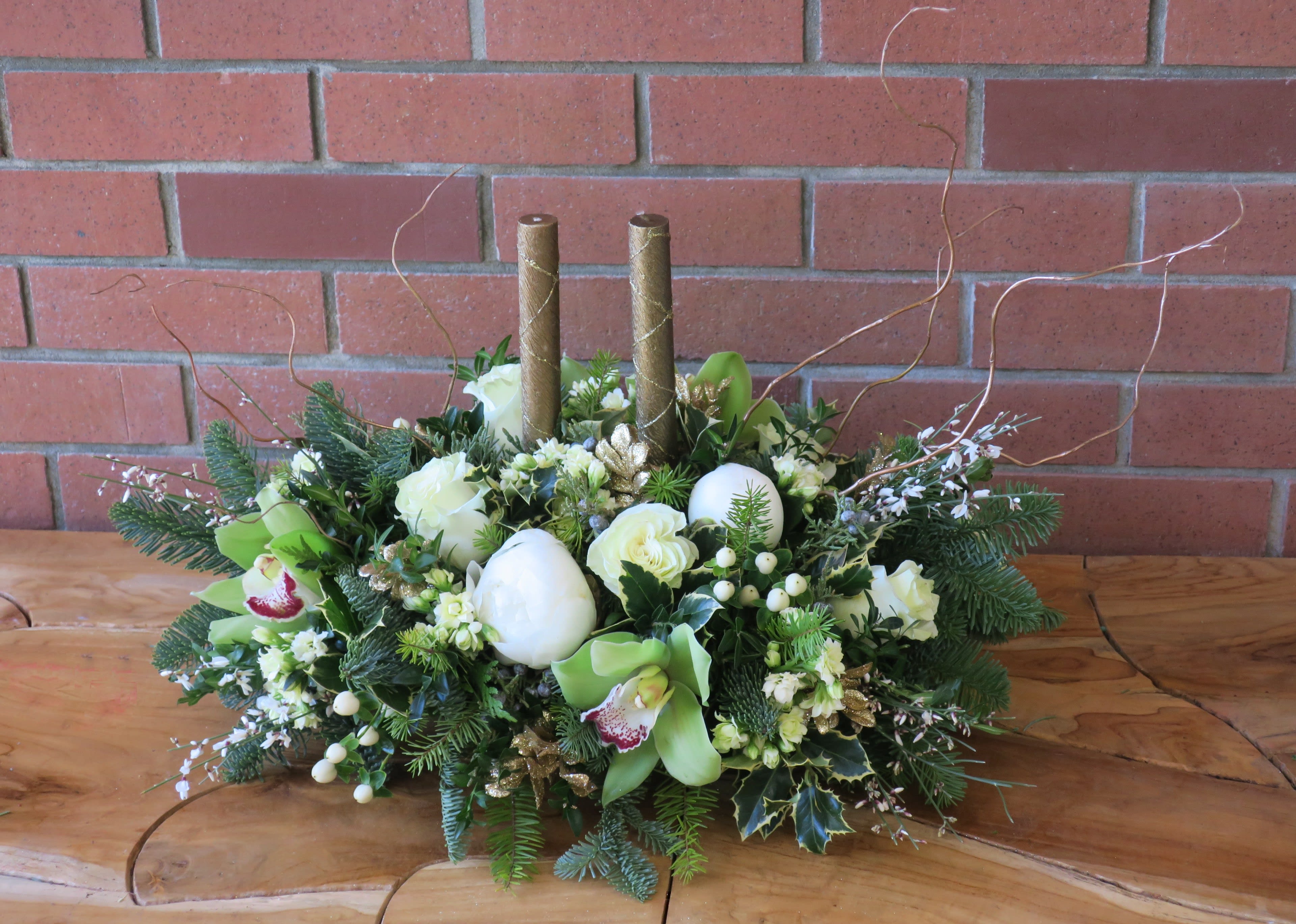 Lush Gold Centerpiece - Gorgeous centerpiece with lush white peonies, green orchids, roses and evergreens accented with gold branches. 