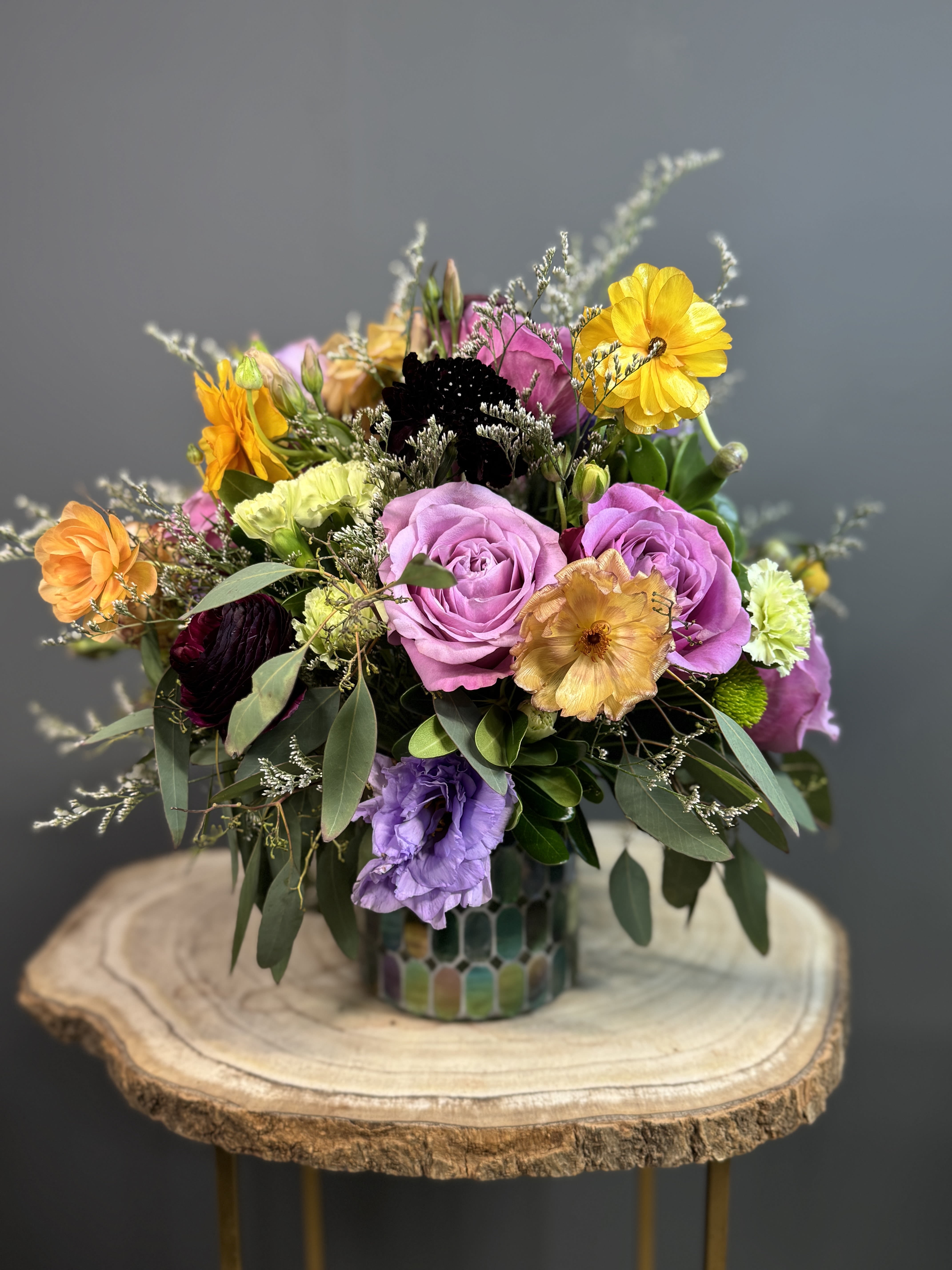 Green Symphony Mosaic - A vibrant medley of lavender roses, golden blooms, and fresh greenery arranged in a stunning mosaic vase. Perfect for brightening any room or gifting with style.