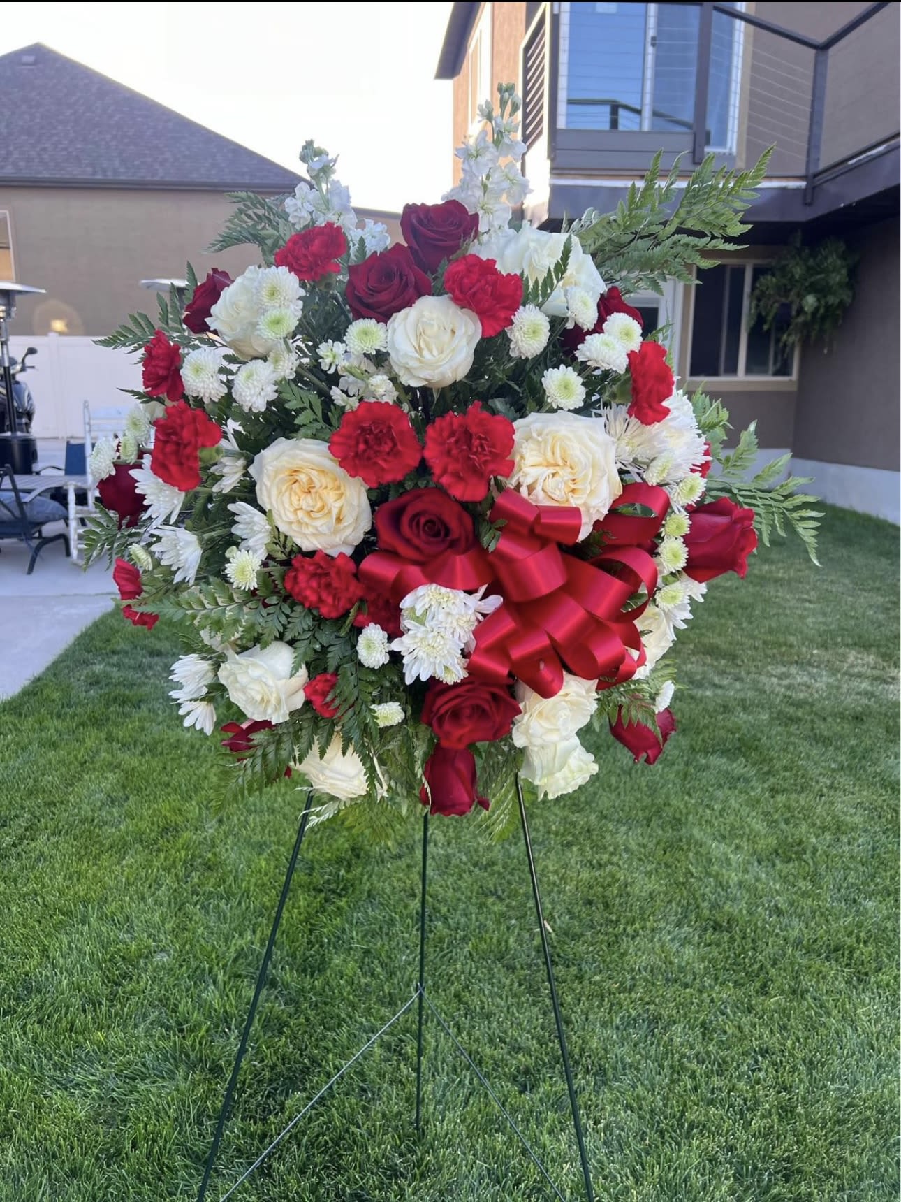 Eternal Love Spray - Honor their memory with our elegant Eternal Love Spray, featuring a classic combination of red and white fresh flowers, including roses, carnations, and chrysanthemums, accented with lush greenery and a satin bow. Perfect for funeral services, memorial ceremonies, and celebrations of life in West Jordan, Utah. A thoughtful and timeless tribute to express your heartfelt condolences.#EternalLoveSpray #FuneralFlowers #RedAndWhiteFlowers #StandingSprayWestJordan #FuneralTribute #CelebrateLife #HonorTheirMemory #WestJordanFlorist #UtahFlorist #SympathyFlowersUtah #FreshFlowersWestJordan #FuneralArrangement 