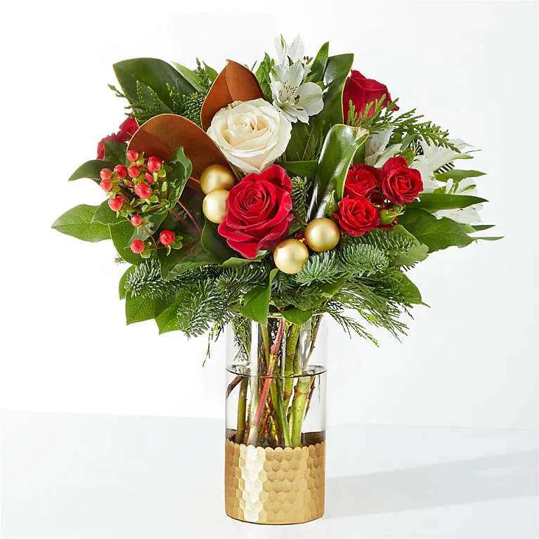 Noel - Spread joy this holiday season with a shimmering arrangement of roses, alstroemeria, and the incredible scent of seasonal greens.