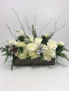 Winter Magic - A magical mix of everyone's favorite fragrant evergreens along with white roses, white carnations, and white hydrangea. A beautiful gift for the holiday table! 