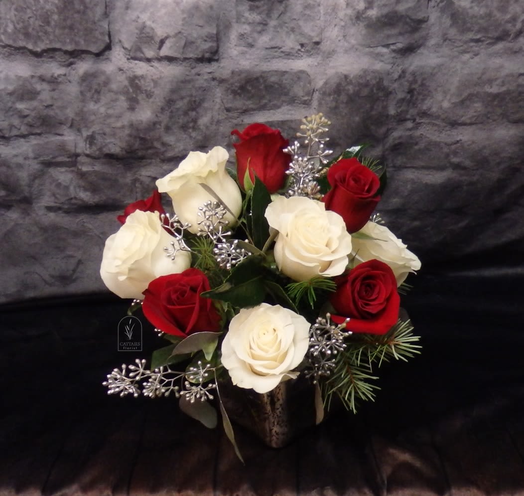 Mistletoe Kisses - Small cube arrangement with Red and White Roses compact style and accented with silver.