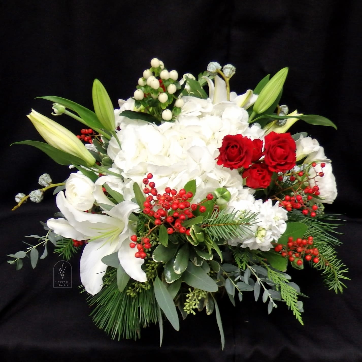 Christmas Blessings - Compact style cube, Christmas vase arrangement. Hydrangeas, Lilies, Berries, Stock, Spray Roses, Roses