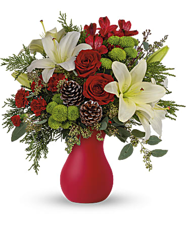  Holiday Greetings Bouquet - Thank your hostess for host  the holiday party sending this enchanting bouquet in a timeless matte red vase. You'll be assured of a warm welcome! Red roses and carnations, green button chrysanthemums and white lilies pop against a background of lush winter greens.