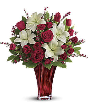  Passion Love Bouquet - This passionate display of red roses, red spray roses, red tulips, and white asiatic lilies is accented with red leptospermum, leatherleaf fern, and lemon leaf. 