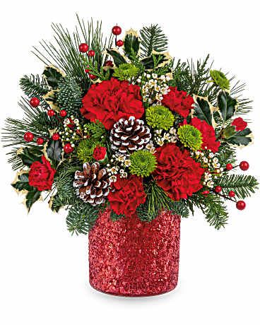 Teleflora's Crimson Wishes Bouquet - Teleflora's Crimson Wishes Bouquet dazzles with red and green holiday blooms, accented by festive greenery and pinecones. Arranged in Teleflora's sparkling red Magical Wish Vase, it's a joyful gift for the Christmas season. 