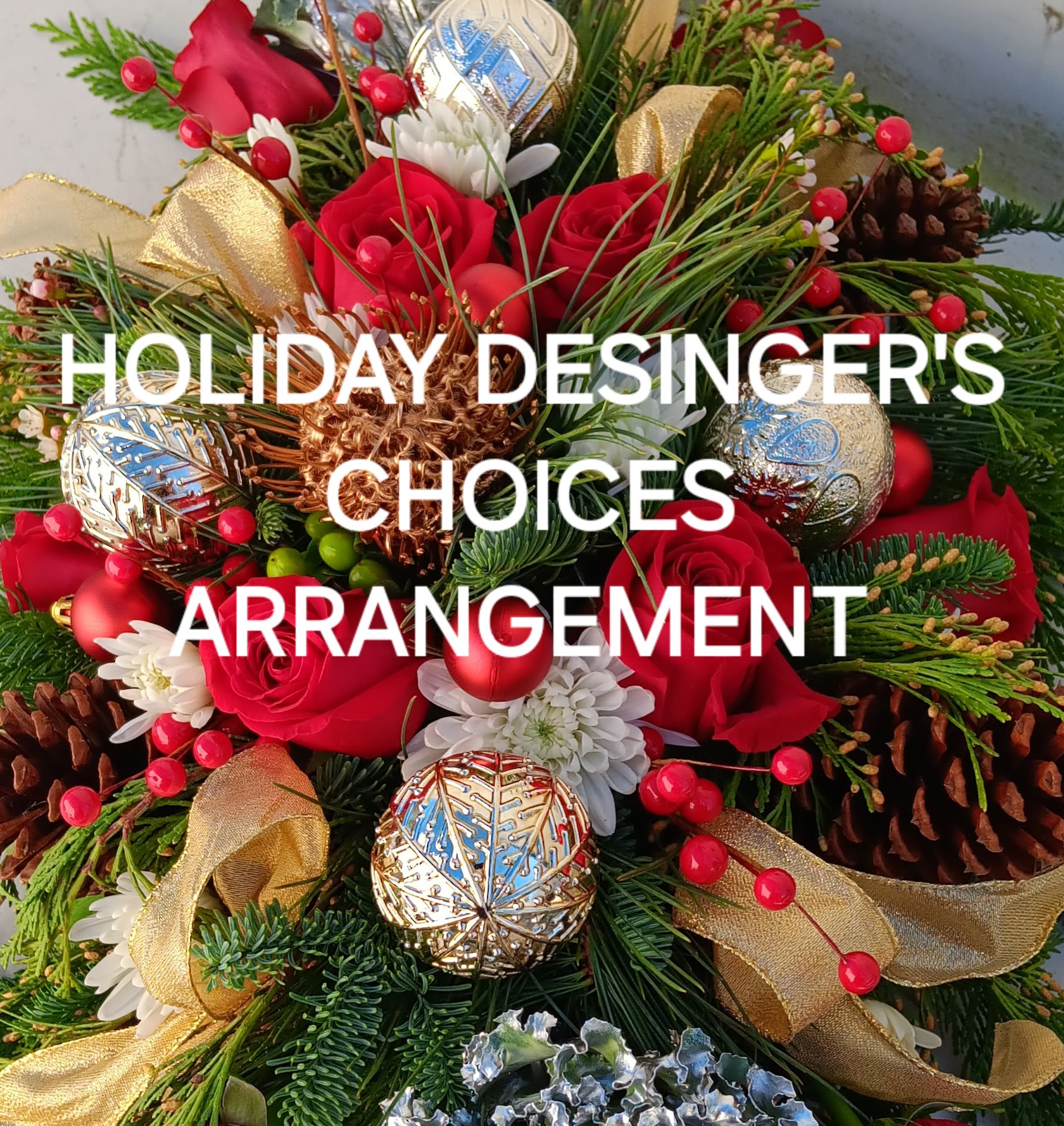 Holiday Designers Choice Arrangement - Celebrate this holiday season with an artfully created floral arrangement. 