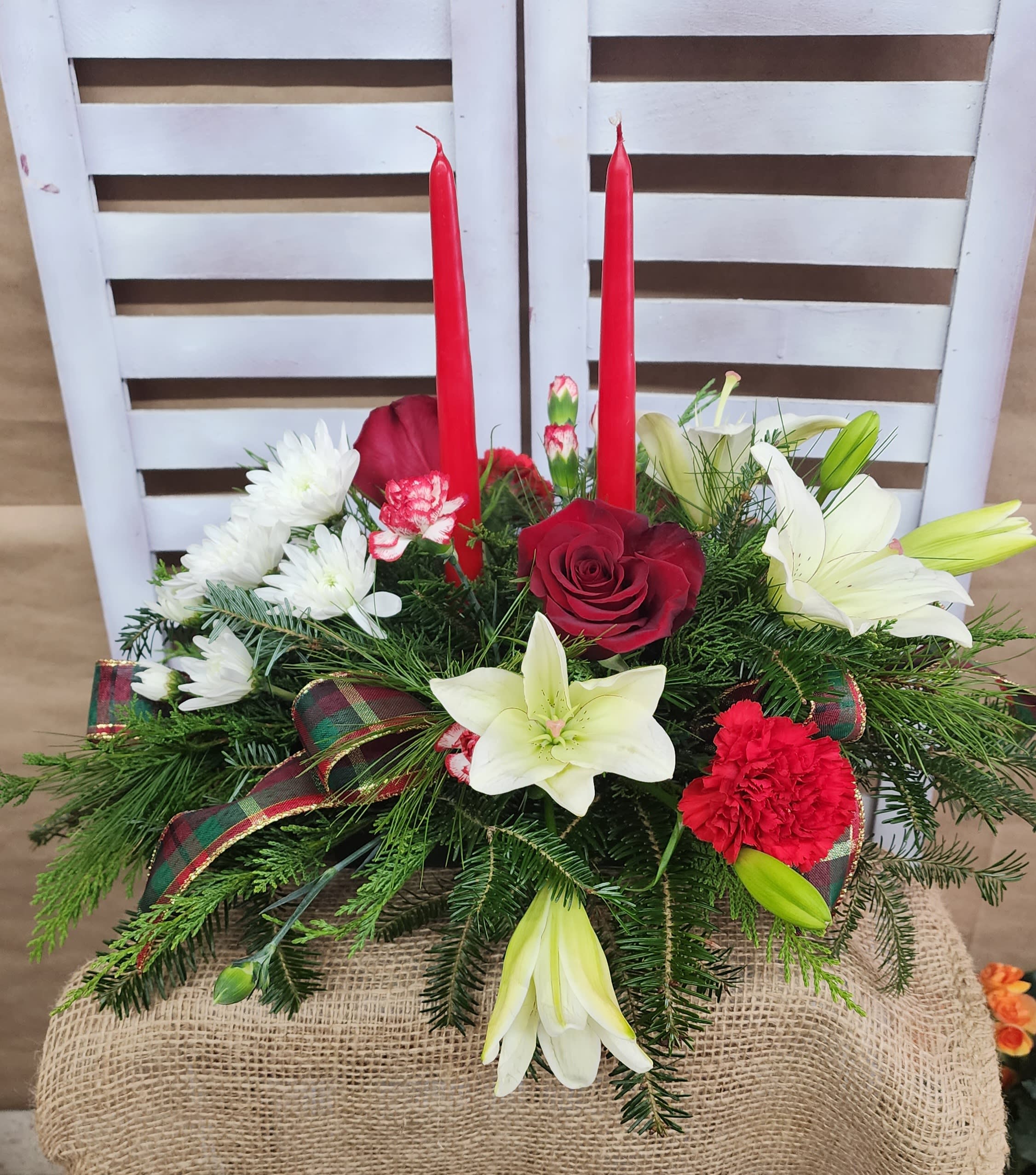 Come All Ye Faithful - Long and low tow candle centerpiece with a beautiful mix of seasonal colored flowers.