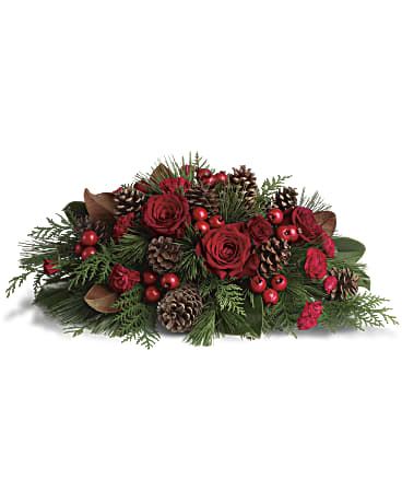 Spirit of the Season - Red roses, red berries, Christmas greens and pinecones - yep, it's Christmas alright! This beautiful Christmas floral centerpiece adds seasonal spirit to the dining room table, the mantle or your entryway where it gives a festive welcome to your guests. Red roses and carnations mix with red berries, pinecones and seasonal greens such as white pine, flat cedar and magnolia leaves. Orientation: All-Around  SUBSTITUTION POLICY – Always deliver the freshest flowers! Please note the bouquet pictured reflects our original design.  If the exact flowers or container in this arrangement are not available, our local florists will create a beautiful bouquet with the freshest available flowers.