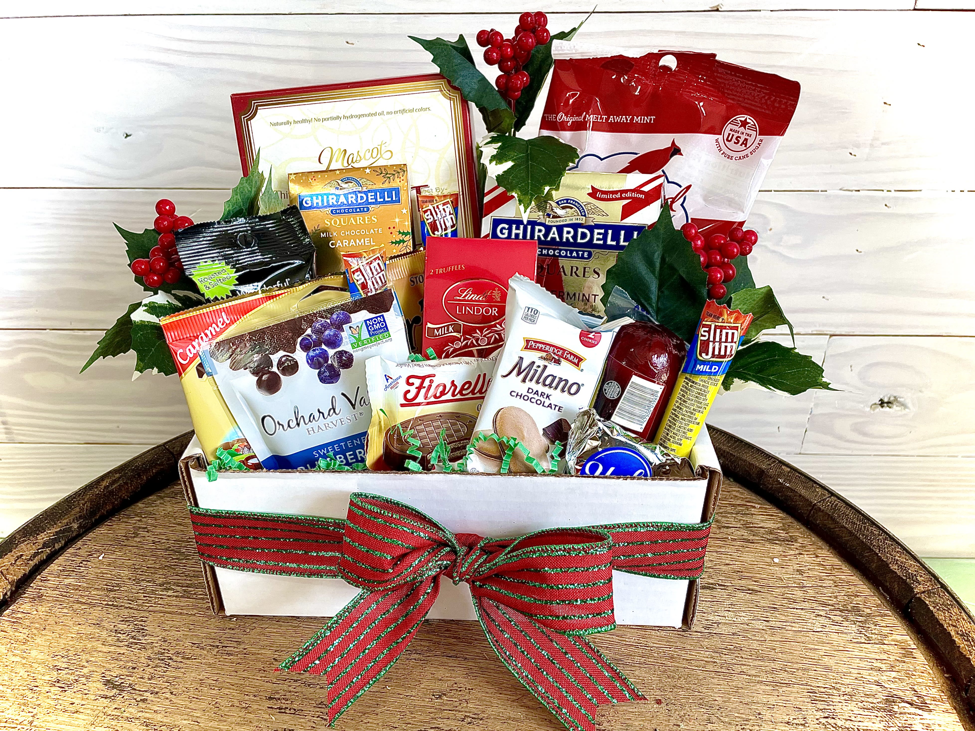 Christmas Snack Box - Filled with a multitude of candy, chocolate, cookies, and other various snacks! A perfect Christmas gift for the snacker in your life.... Psst! It's me. I'm the snacker... ****We will try our best to match the flowers in the picture, but there may be times when we substitute flowers. We will always try to make it have the same look and feel as the original.****