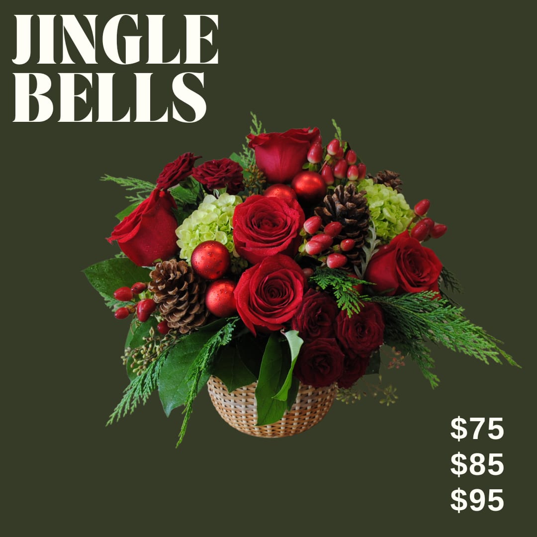 Jingle Bells- red winter centerpiece  - Jingle Bells is a low and lush bouquet artfully designed in a nantucket basket using red toned florals, and winter accents and greens!!  *Image shown is valued at $95 *The $75 and $85 price points will be made with fewer flowers to match the value using blooms in the same color palette