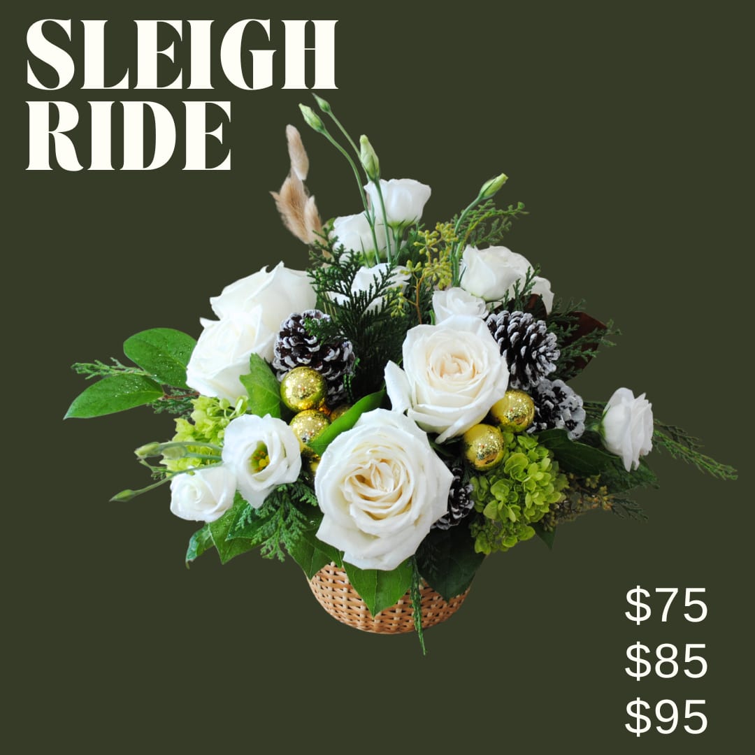 Sleigh Ride- White Winter Centerpiece  - Sleigh Ride is a low and lush bouquet artfully designed in a nantucket basket using white florals, and winter accents and greens!!  *Image shown is valued at $95 *The $75 and $85 price points will be made with fewer flowers to match the value using blooms in the same color palette