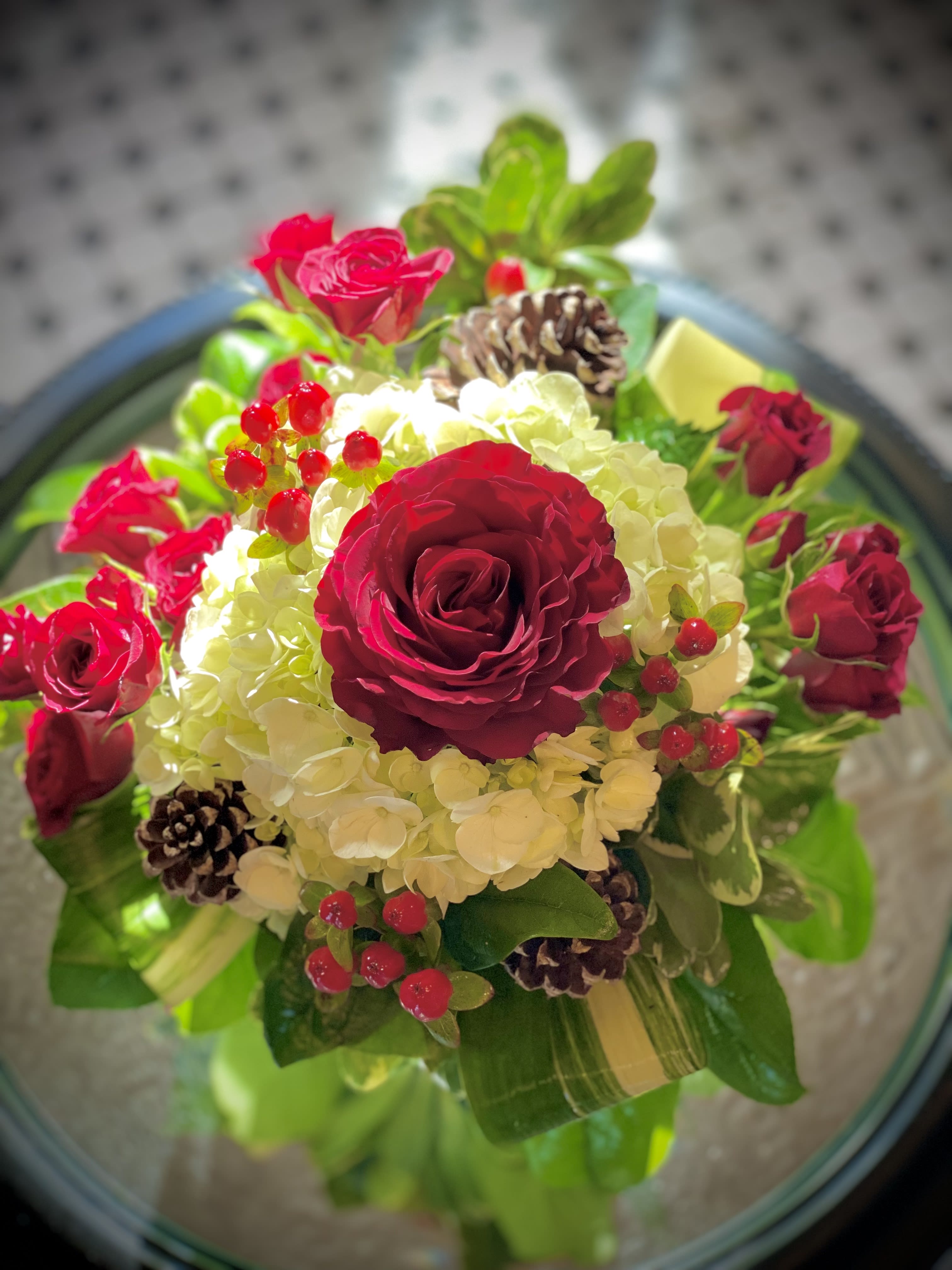 Joyful - Elegant and simple, this beautiful fresh bouquet is sure to add joy to anyone's holiday. Includes roses, hydrangea, holly and pinecones in a compact and petite design. Arrangement is 12 inches by 10 inches.