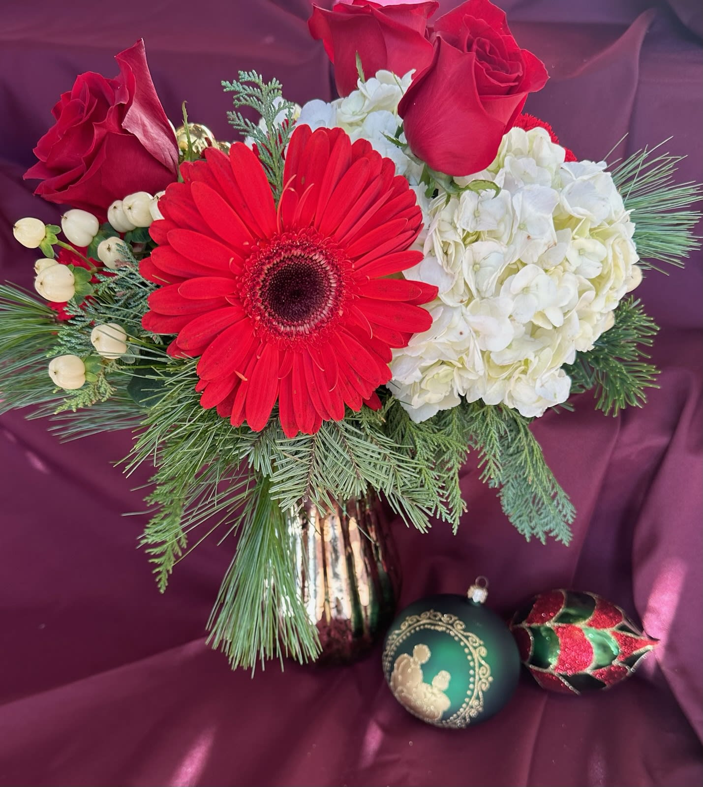 Golden Christmas Bouquet - Red and white blossoms arranged in a gold mercury glass vase with fragrant winter greens. Our Custom Christmas Collection are made from our freshest blooms of the season! Some substitutes may be made with similar premium flowers.