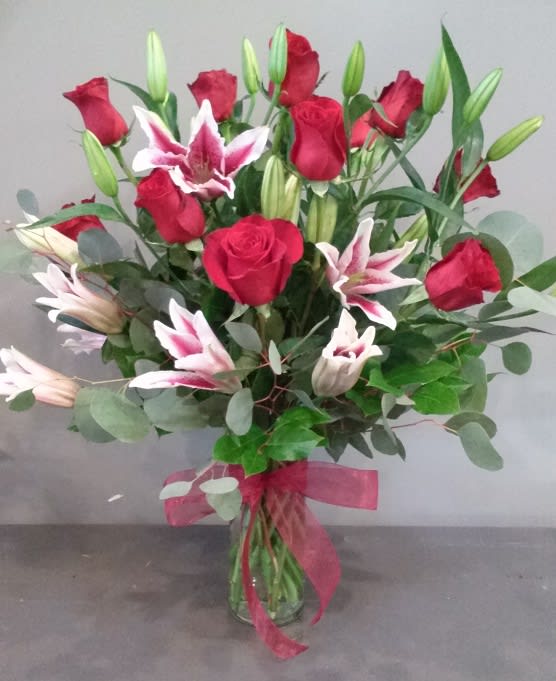 Gazing Love - A mix of roses and stargazer lilies will fill the room with so much beauty!