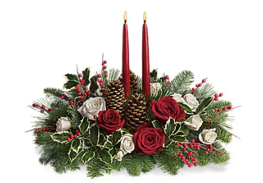 Holiday Wishes Centerpiece - Elegant. Lovely. Radiant. This beautiful Christmas centerpiece is everything you could wish for and more. Stunning red and white roses and chrysanthemums plus all of your holiday favorites like pinecones, berries, holly, Christmas greenery, and two tall-tapered candles. A brilliant way to send your Christmas wishes in style. 
