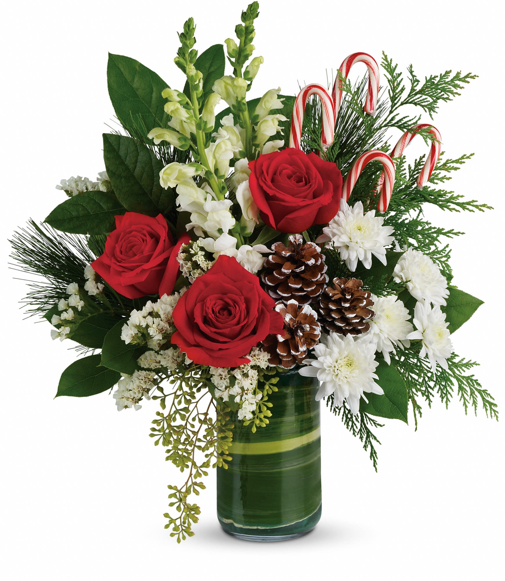 Festive Pines Bouquet - Bursting with Christmas spirit, this lush rose bouquet is accented with candy canes and pine cones for a touch of festive fun.  Red roses, white snapdragons, and white cushion spray chrysanthemums are wrapped in a variegated aspidistra leaf and accented with seeded eucalyptus, lemon leaf, flat cedar, white pine, candy canes, and small frosted pinecones. Delivered in a clear glass cylinder vase. Approximately 16&quot; W x 17 1/2&quot; H