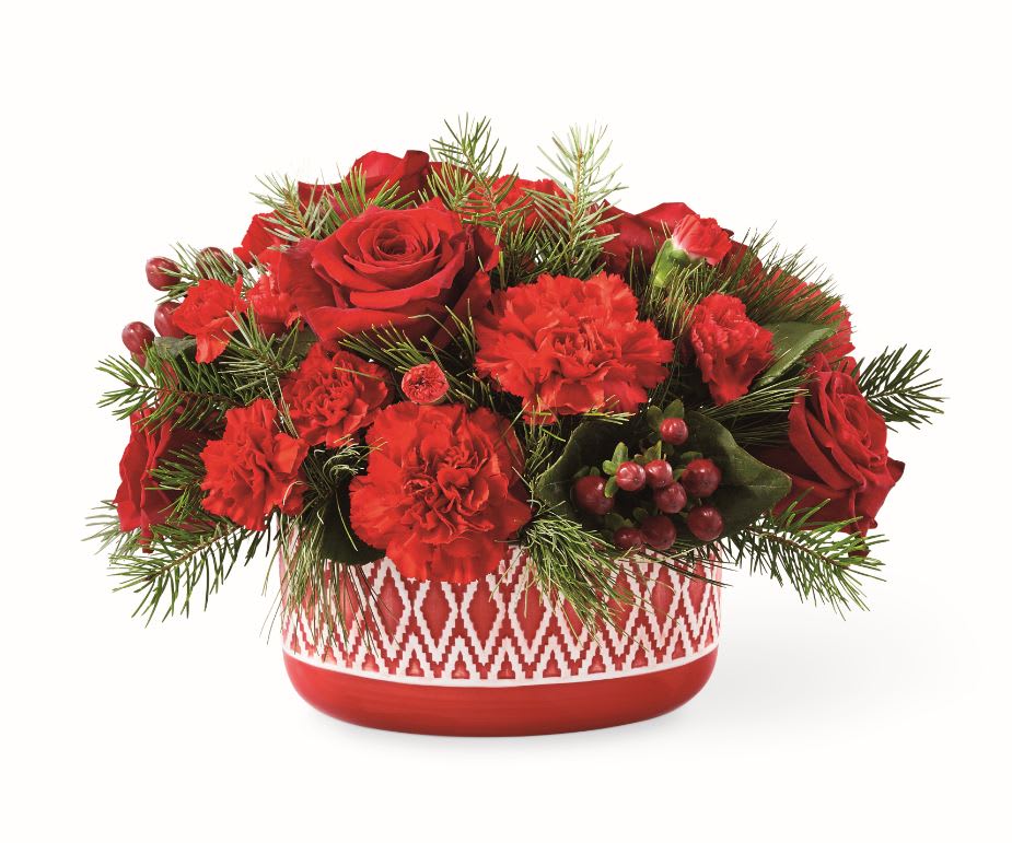 COZY COMFORT™ BOUQUET  - An array of red blooms fill a Nordic-inspired sweater-patterned red ceramic vase, creating a beautiful gift that is worth celebrating. Container may vary.