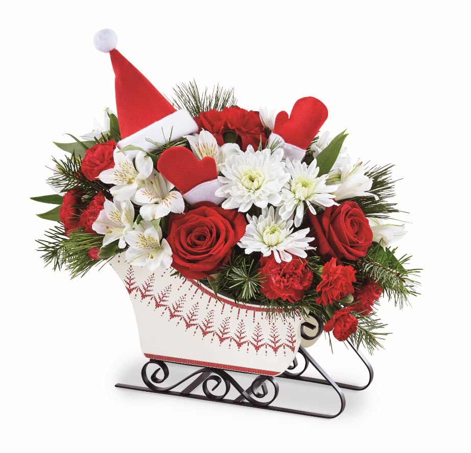 DASHING THROUGH THE SNOW™ BOUQUET  - A sleigh (sled type may vary) with metal runners and festive  Santa hat pick makes for the perfect Christmas greeting that your customers will love for years to come. 