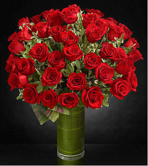 Fate Luxury Rose Bouquet - Fate brought you together for this one incredible moment. Celebrate your love and heartfelt emotion with a display of the most amazing roses. A gorgeous and lush bouquet of  premium long-stemmed red roses, beautifully situated in a clear glass vase, are the perfect way to shine a light on your every emotion. 12, 24 and 36 stem count premium long-stemmed red roses, assorted greens, exotic foliage and a  clear glass  vase. Approx. 26H x 23W Your purchase includes a complimentary personalized gift message.