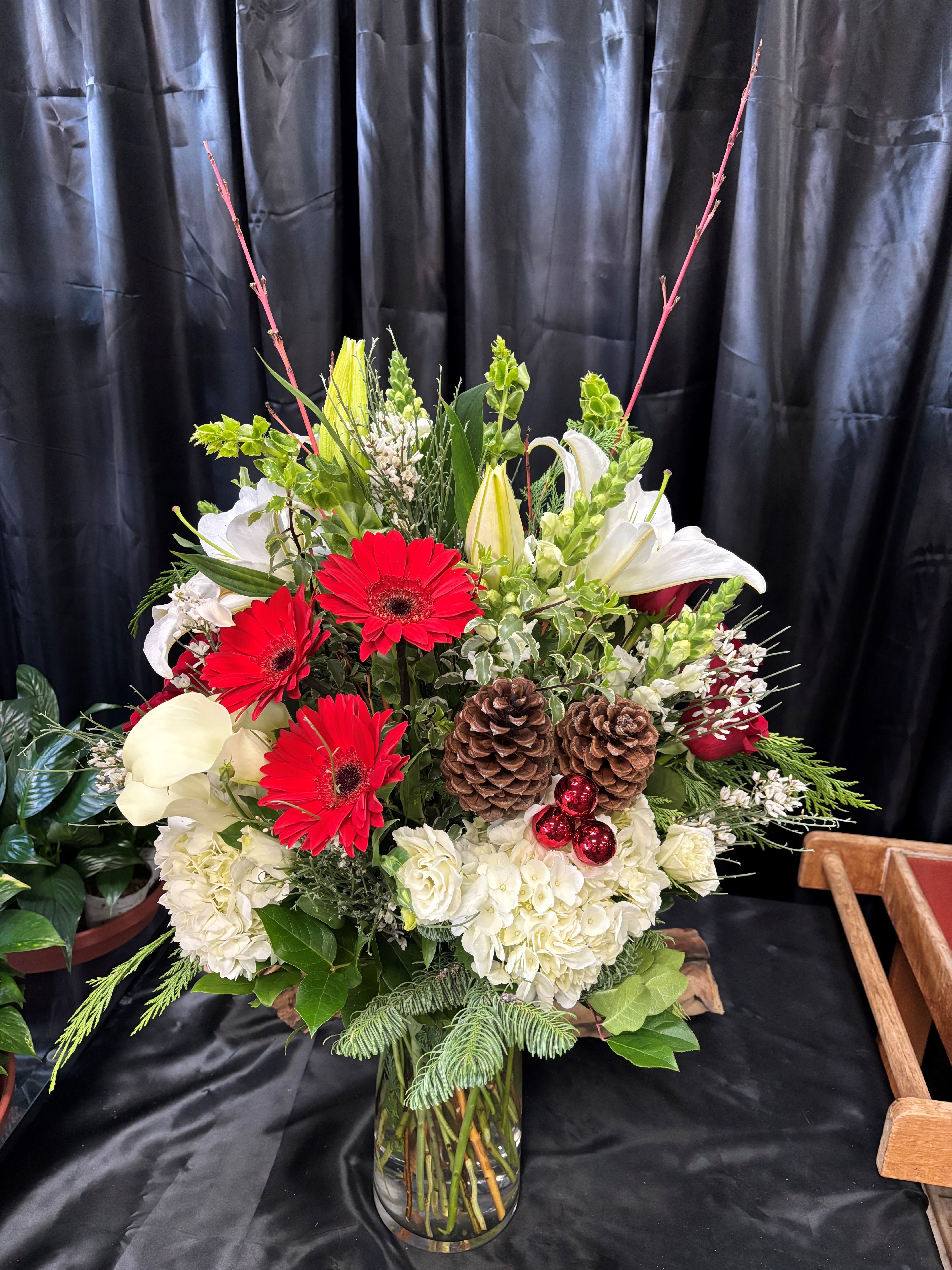 Christmas Tradition - A traditional floral arrangement in red, white and green with Christmas ball accents