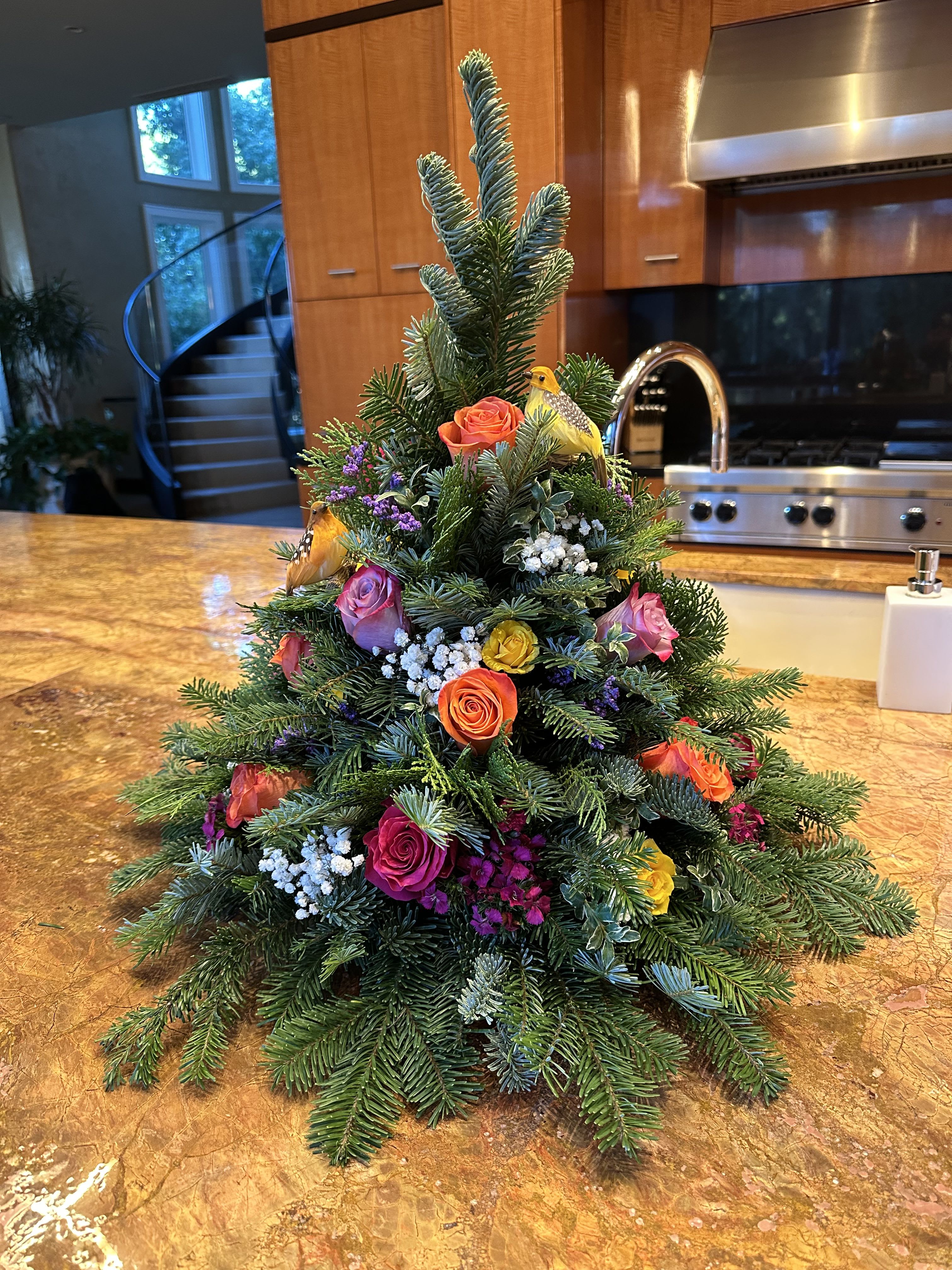 Colorful Christmas - A hand made holiday tree with colorful floral. Colors may vary