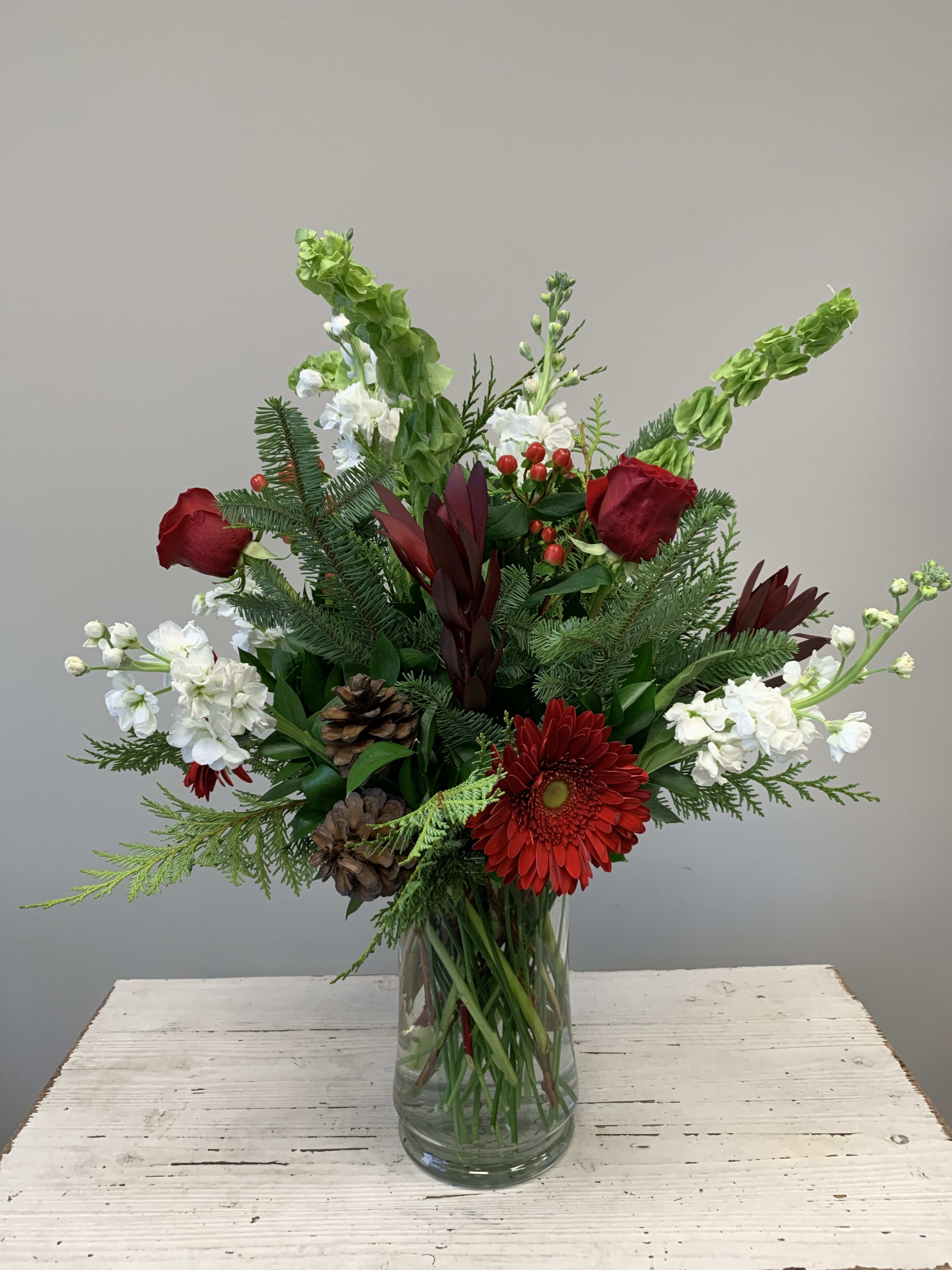 Holiday Joy  - This beautiful arrangement is perfect for someone this holiday.  Red white and green flowers will put a smile on someone’s face for sure.