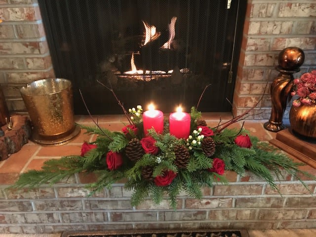 Warmest Holiday Traditions  - Designed with the freshest winter greens, red roses, dogwood branches and accented with pinecones. Finished with candles for the warm glow for any dinner. 
