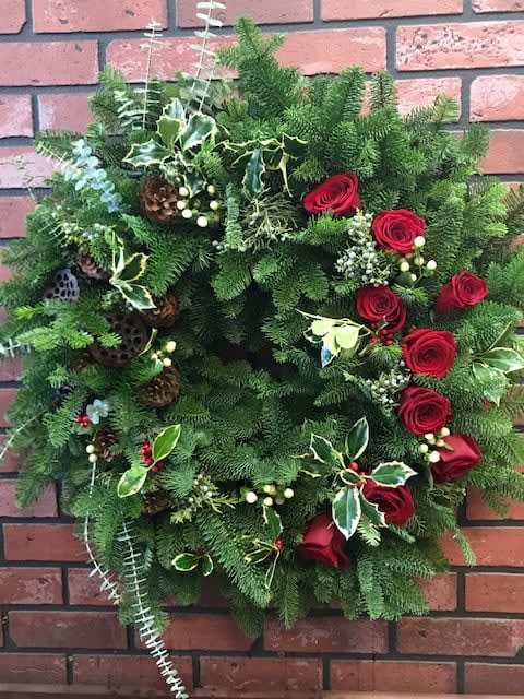 Holiday Wreath - Handmade holiday wreath with the freshest winter greens. Completely customizable with any color of roses or accents desired. Perfect for the front of anyone's door. 