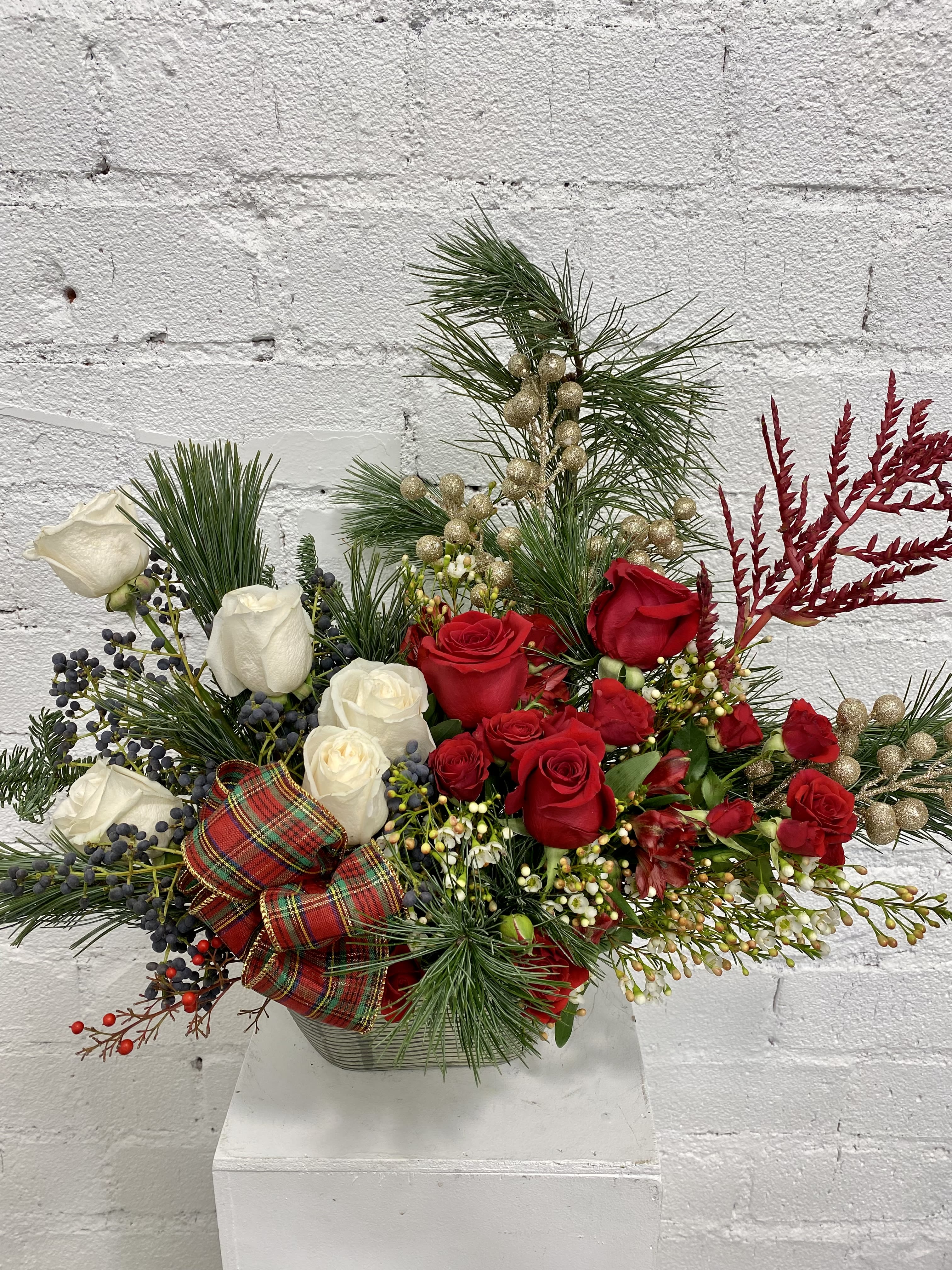 The best time of the year - Christmas floral arrangement with some extra decorations in red green and white.