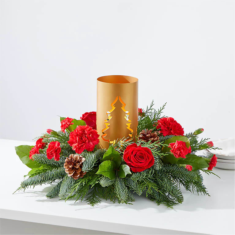 Making Memories Centerpiece - Add blustery cheer to any holiday table with this coniferous centerpiece studded with cardinal–red flowers gathered around a glowing candlelit tree lantern.
