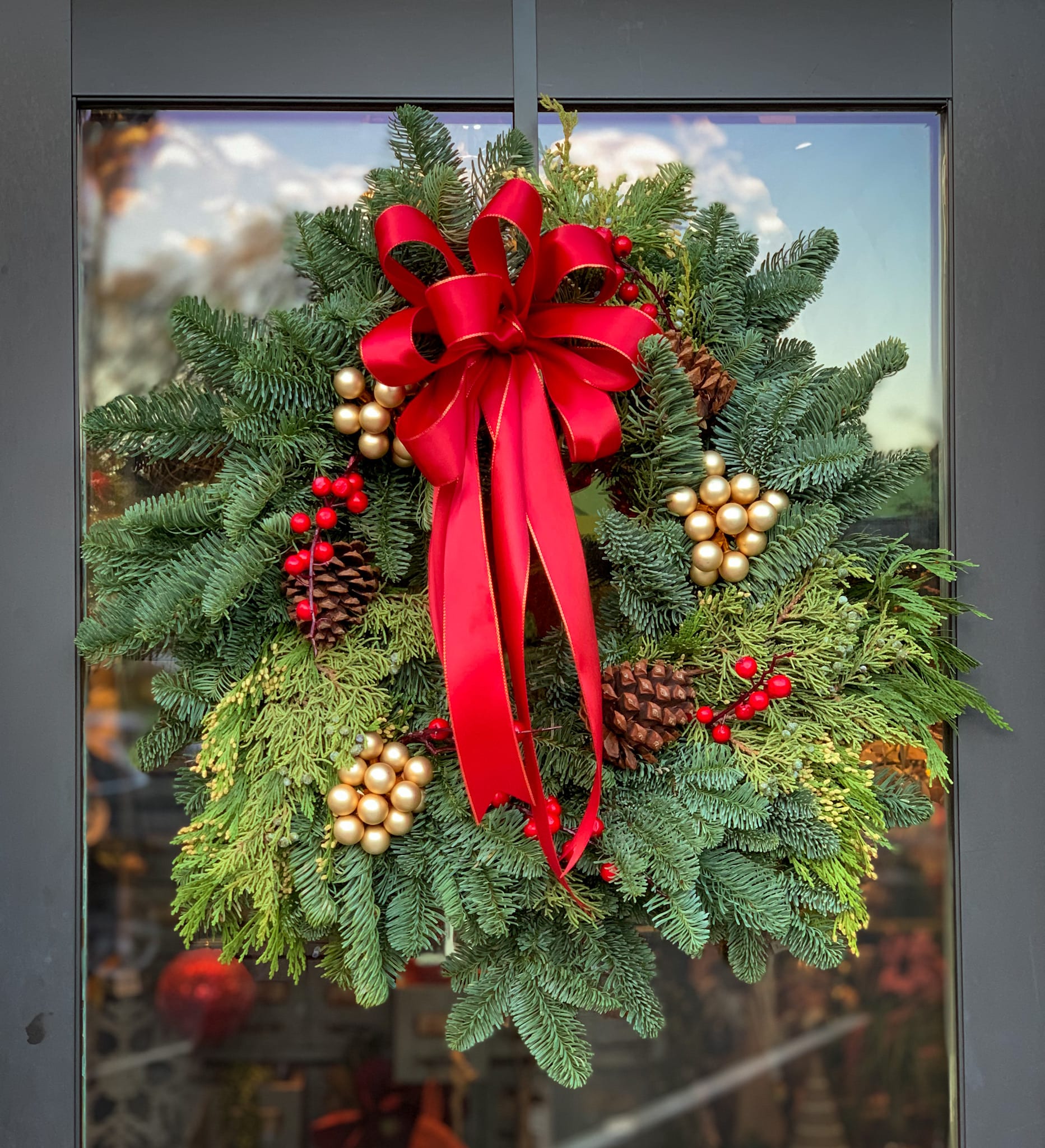 Winter Wreath - This festive wreath made with real evergreen branches will brighten up any entrance, inviting the warmth of the holidays to begin. 