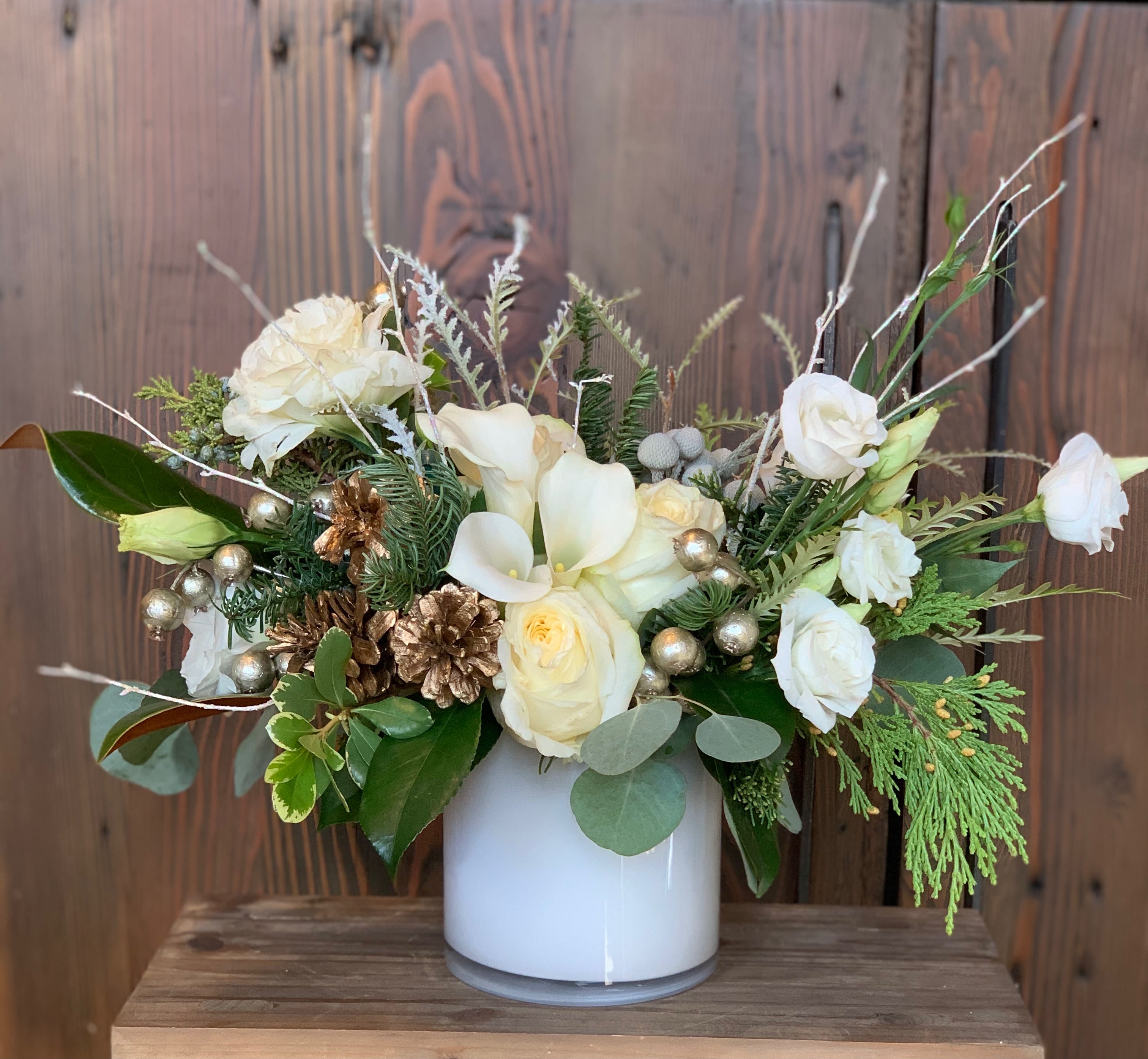 Snowburst - Enter the wondrous snowy realm of holiday delight with this elegant arrangement. Filled to the brim with gold accents and delicate details, this arrangement will be sure to bring the child-like wonder of the holidays to anyone's eyes. 
