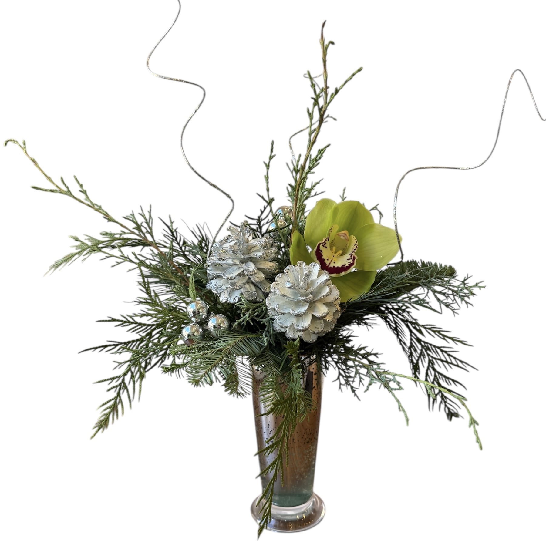 Silver Bells  - Green cymbidium orchid with holiday greens and holiday decor, designed in a tall silver glass vase. As shown in photo.