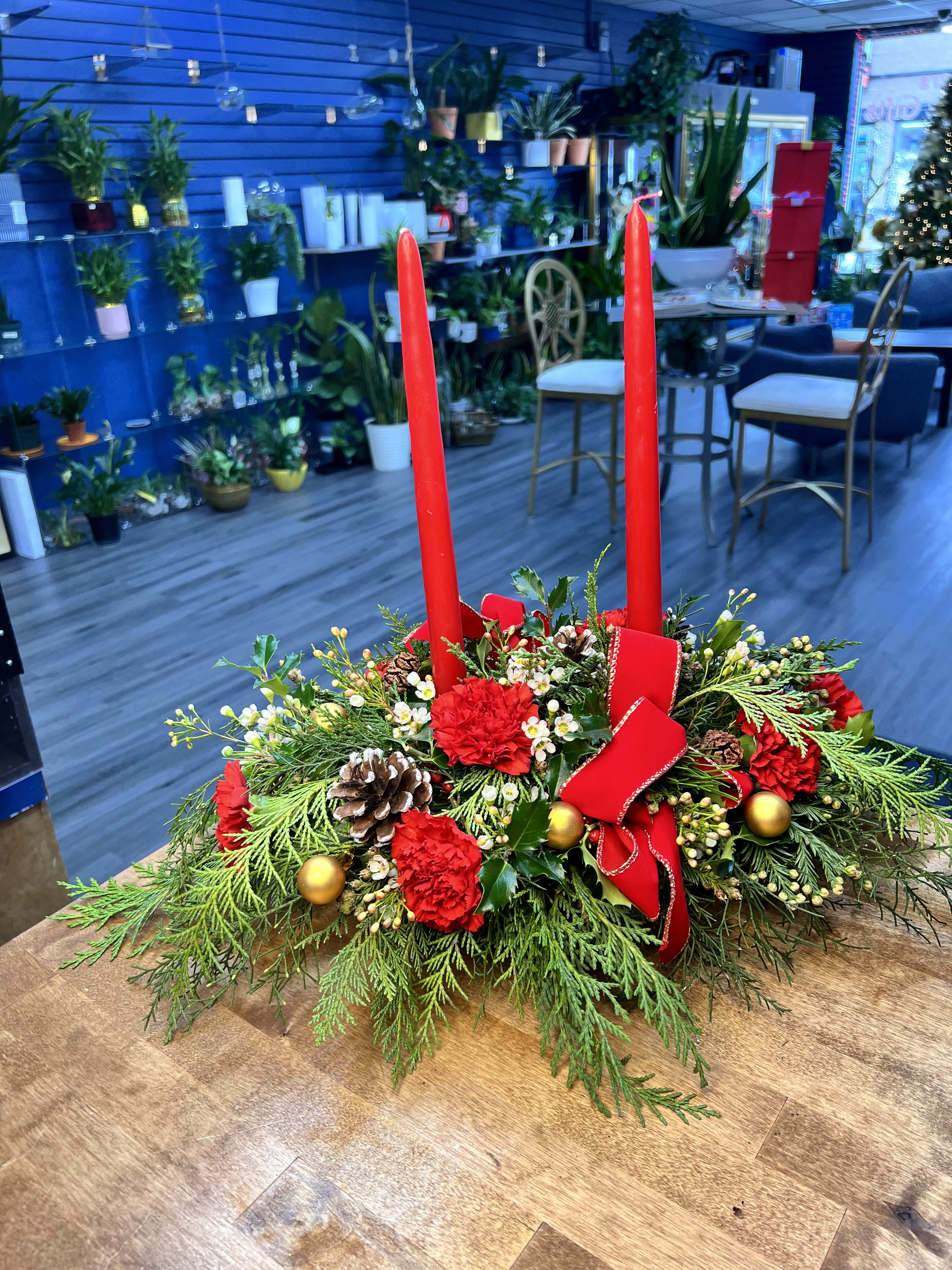  Christmas centerpiece  - "Explore our charming collection of candle arrangements, adorned with red carnations and exquisite Christmas foliage. Each piece is carefully crafted to illuminate your space with the warmth of the season and add a festive touch to your home. Perfect for creating a cozy atmosphere during holiday celebrations."