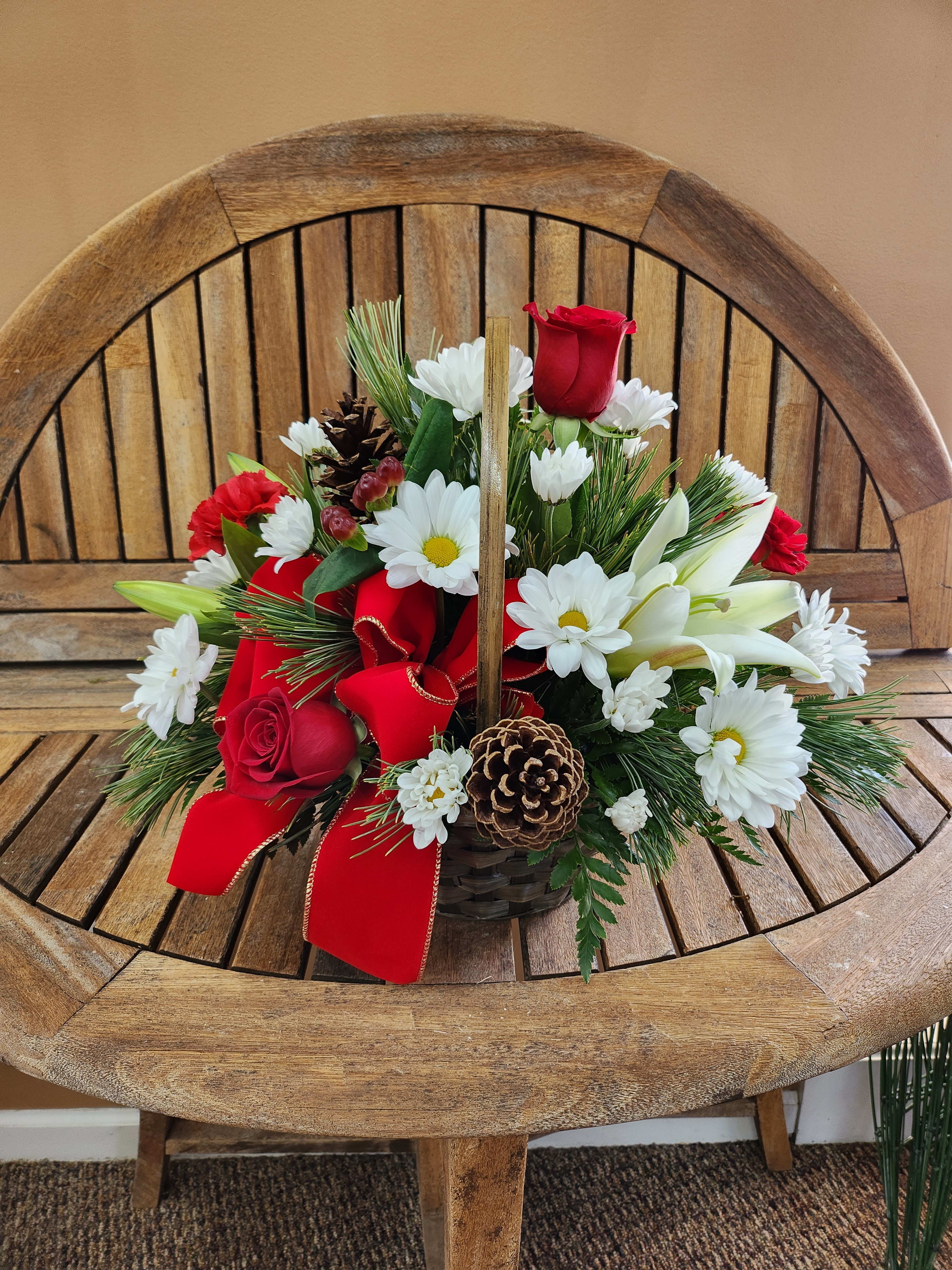 Festive Holiday Blooms Basket - Basket with Christmas ribbon,  red and white flowers, pinecone and Christmas greens. Ribbon may vary