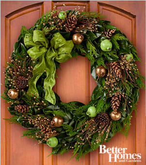 The FTD® Woodland Beauty Holiday Wreath by Better Homes and Gardens® - FTD® proudly presents the Better Homes and Gardens® Woodland Beauty Holiday Wreath. Starting with a base of lush, green magnolia leaves, this gorgeous wreath is bedecked with golden pomegranates, gold berries, and natural birch twigs to create a stylish look. Accented with a simply stunning sage green bow, this holiday wreath will make that perfect impression when hanging from your own front door, but also is an exceptional Christmas gift for those friends and family that mean so much. Wreath measures 24-inches in diameter. Do not place in direct sunlight as the coloring may fade. Your purchase includes a complimentary personalized gift message.
