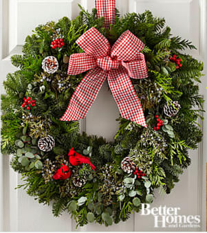 The FTD® Holiday Homecoming Wreath by Better Homes and Gardens® - FTD® proudly presents the Better Homes and Gardens® Holiday Homecoming Wreath. An exquisite way to greet your Christmas friends and guests, this fresh holiday wreath will make that perfect impression. Consisting of a Base of Noble Fir, Western Red Cedar and berried juniper, this wreath is then bedecked with pine cones and cardinals to create an incredible presentation. Accented with a single checked bow, this holiday wreath will be a wonderful addition to your own home décor or make a great gift for friends and family near and far. Approximately 22-inches in diameter. Your purchase includes a complimentary personalized gift message.
