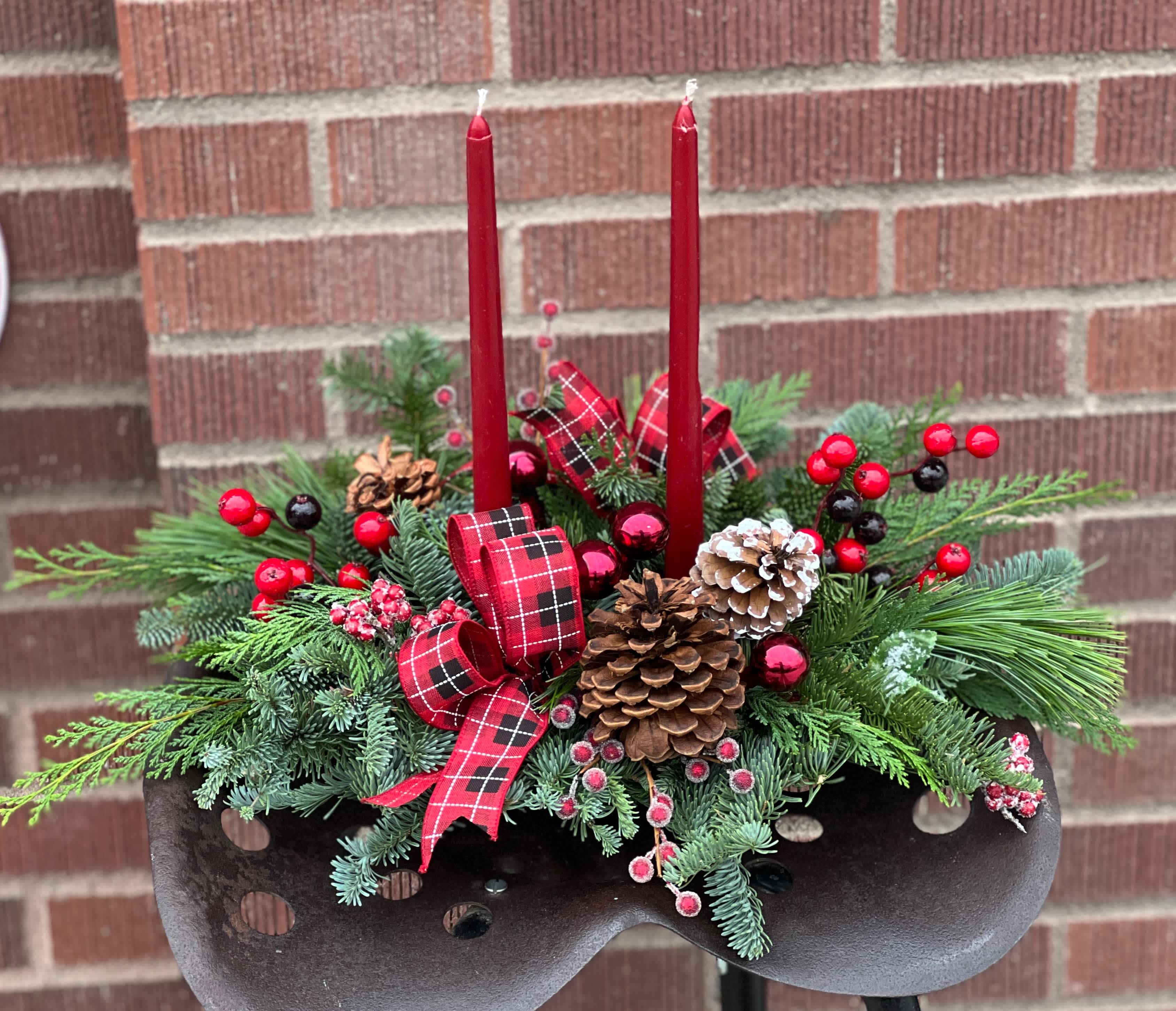 Evergreen Christmas Centerpiece - Made entirely of a variety of Christmas greens, berries, festive ribbon and pine cones with two taper candles, this centerpiece will have the most longevity as an early order option. :) Ribbon may vary, but will match the colors. :)