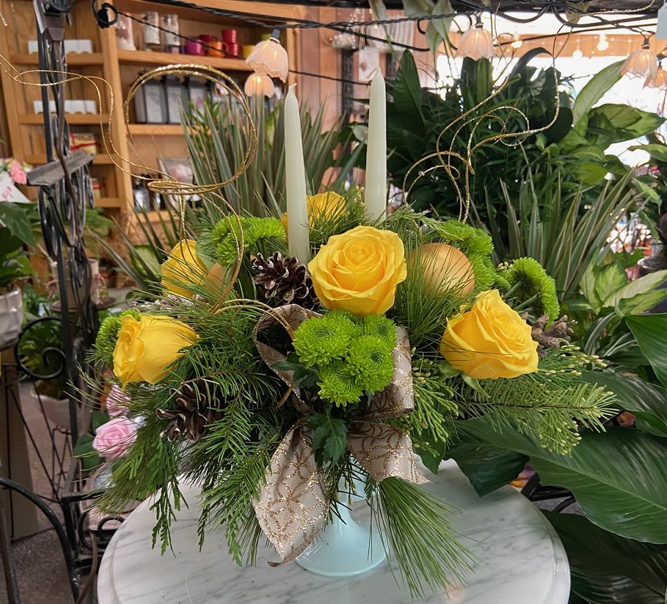 Moonlit Snow - Yellow roses and green button poms are set in fresh cut pine and adorned with pine cones, bows, and gold ting in an elegant milk glass vase.