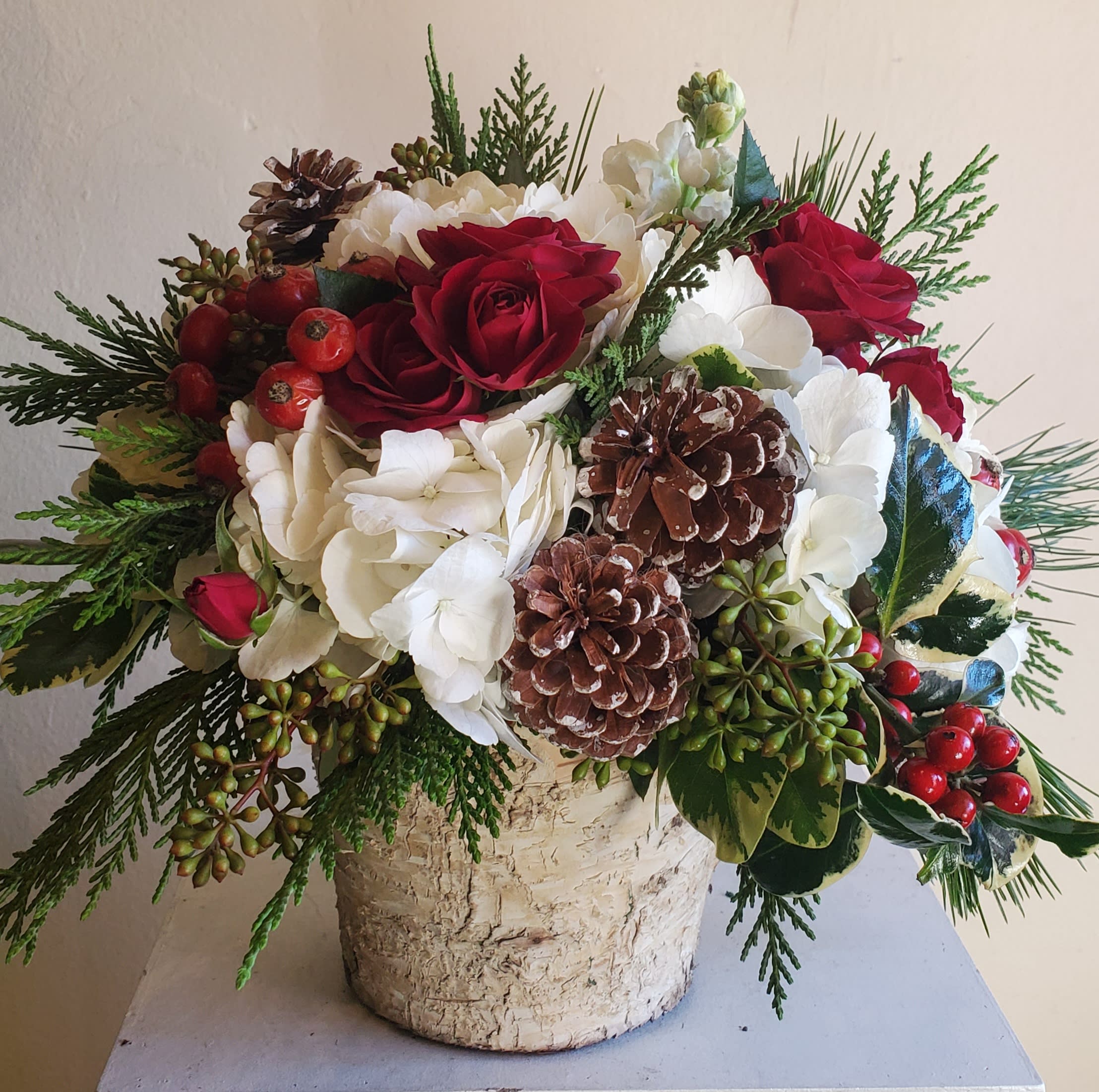 Dashing through the snow - Seasonal arrangement in a birch-lined container or glass cylinder dependant on availability. 
