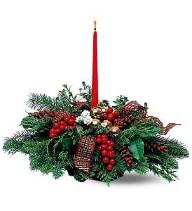 Single Candle Centerpiece - This wintry centerpiece with its holiday decor captures the holiday spirit in all its glory.  Evergreens accented with white flowers, along with berries, pinecones, balls and ribbon, together with a red taper candle in a centerpiece tray.  ** due to supply chain issues ribbon may vary from what is shown***  ALSO CANDLE MAYBE WHITE  ******PLEASE NOTE DUE TO SUPPLY CHAIN ISSUES CANDLE MAYBE WHITE VS RED  Approximately 19&quot; W x 17&quot; H  Orientation: All-Around  