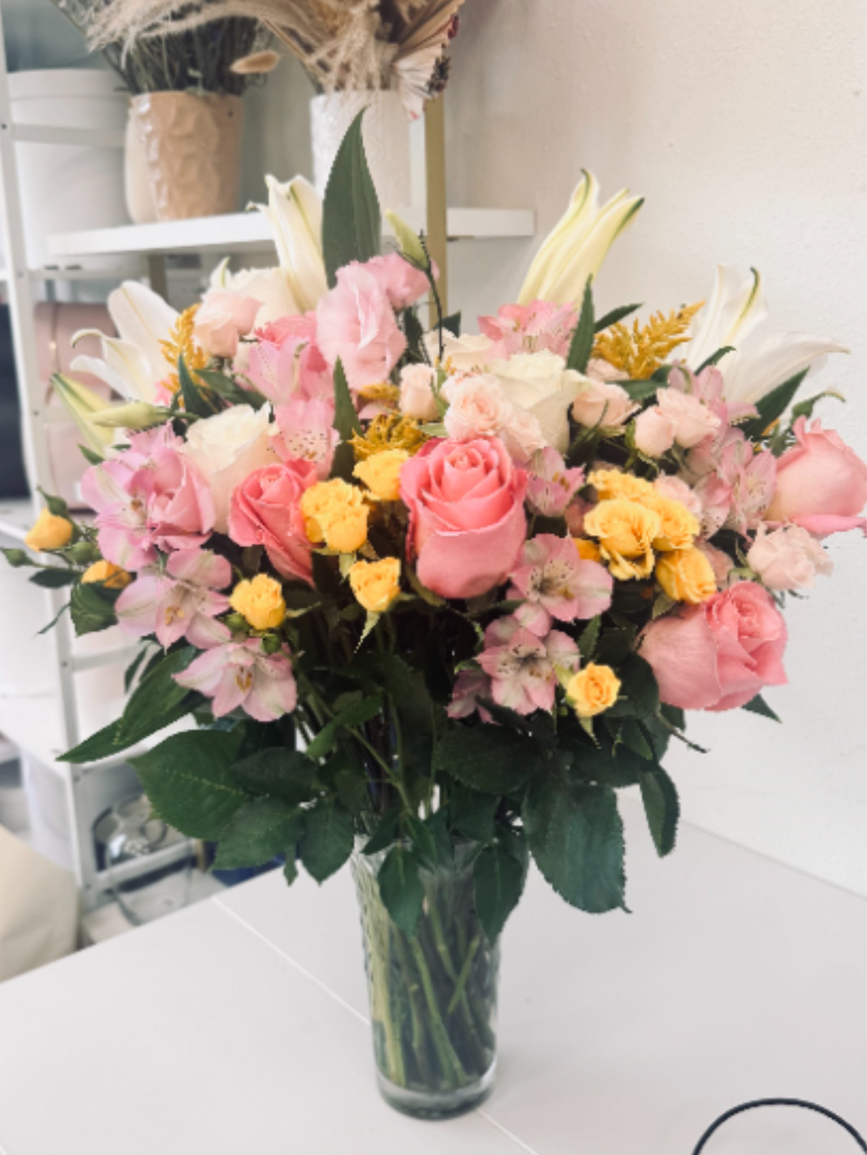 Elegant Lily &amp; Rose Vase Arrangement - A fresh, uplifting mix of lilies, roses, spray roses and alstroemeria designed in a lush glass vase. Soft blooms and airy greenery create a full, garden-style look that feels both elegant and joyful. This arrangement is perfect for birthdays, anniversaries, thank-you gifts or just because. We hand-select each stem to ensure beautiful color harmony and a fresh, long-lasting display. Flowers and greenery may vary slightly by season and daily availability, but the overall style, color palette and value of the arrangement will always be maintained.