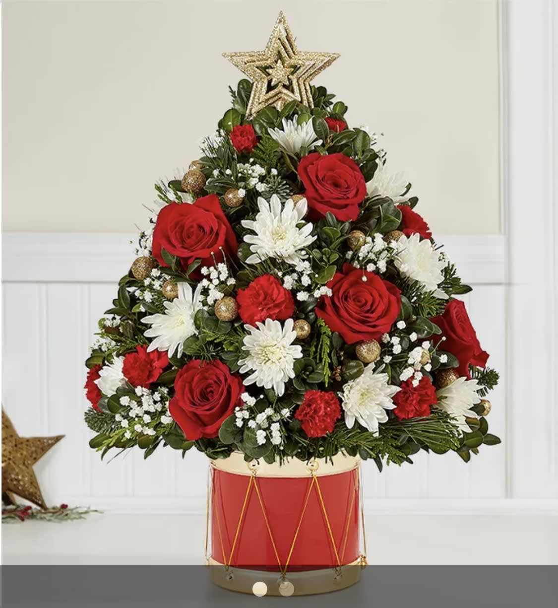Holiday Flower Tree® Musical Merriment™ - EXCLUSIVE The joy of gift-giving comes alive in the latest edition of our iconic Holiday Flower Tree. We’ve trimmed it with festive blooms, glittery gold ornaments and a star on top. Adding to the fun is our exclusive Musical Merriment drum container, inspired by the Nutcracker. Full of vintage charm, it’s a gift that delivers the magic of the season.