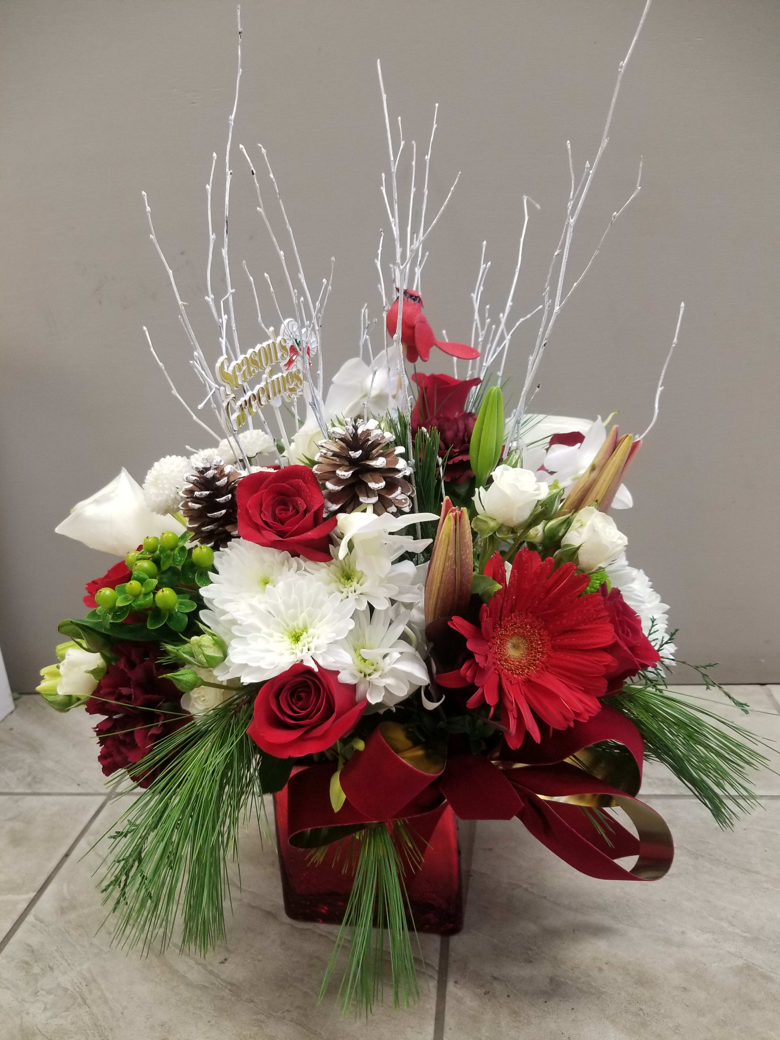 Merry Christmas - Red and white fresh cut flowers with accents inspired by nature in a glass cube vase. It will bring the winter holiday spirit into your house.