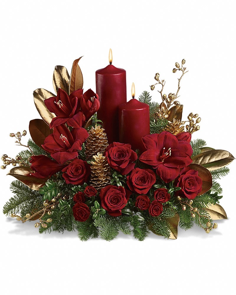Candlelit Christmas - Christmas by candlelight is the perfect way to delight in the warmth and joy of the season. This elegant arrangement will be at home anywhere in the house, adding grace and beauty to any holiday celebration. Ruby red amaryllis, roses and spray roses are perfectly arranged with golden pinecones and holiday greenery. Two pillar candles in a stunning shade of pomegranate are the perfect touch to light up the night.