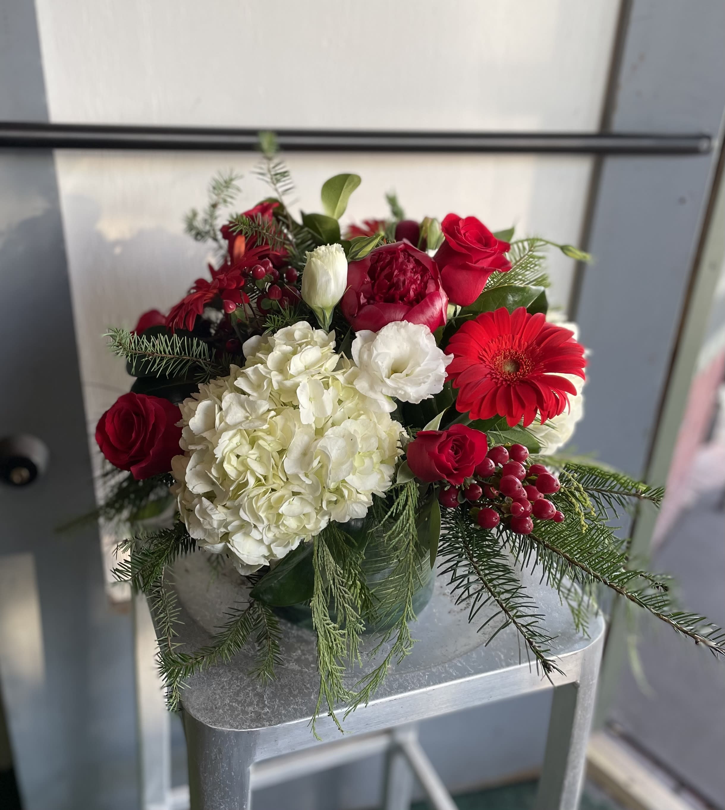 Christmas Centerpiece #2 - Christmas centerpiece with red, white flowers, and seasonal greeneries. 
