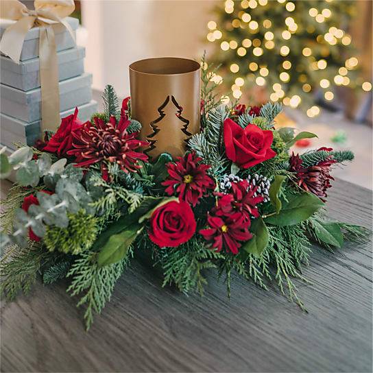 Through the Woods Centerpiece - Rekindle your appreciation for the beauty of a winter landscape with our Through the Woods centerpiece. While much of the natural world is dormant, liven your space with this rustic centerpiece's red florals and bright eucalyptus greenery.