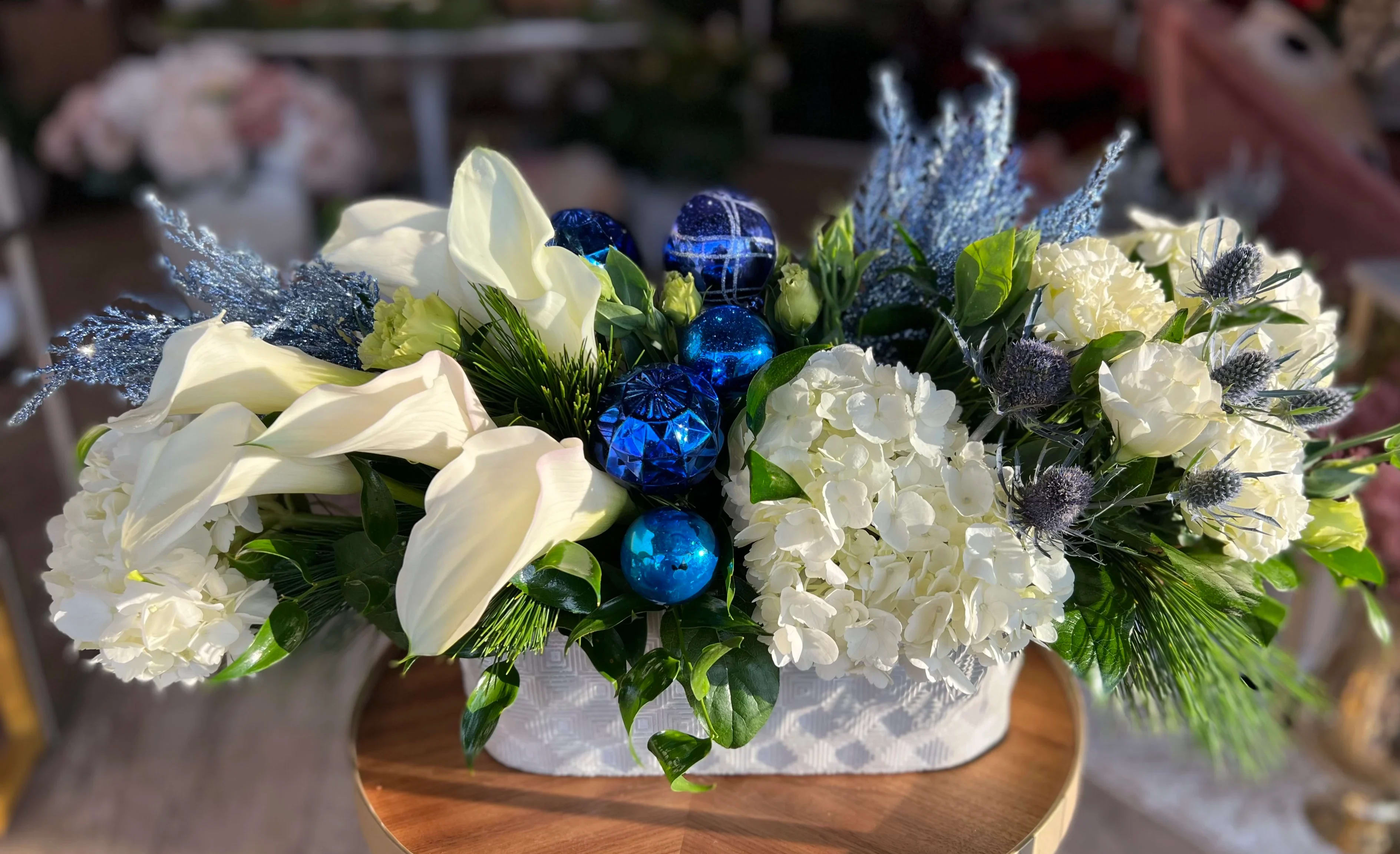 Centerpiece for the Holiday  - Gorgeous all white centerpiece that includes Calla Lillie’s, Hydrangeas, Lisianthus in modern oblong vase 